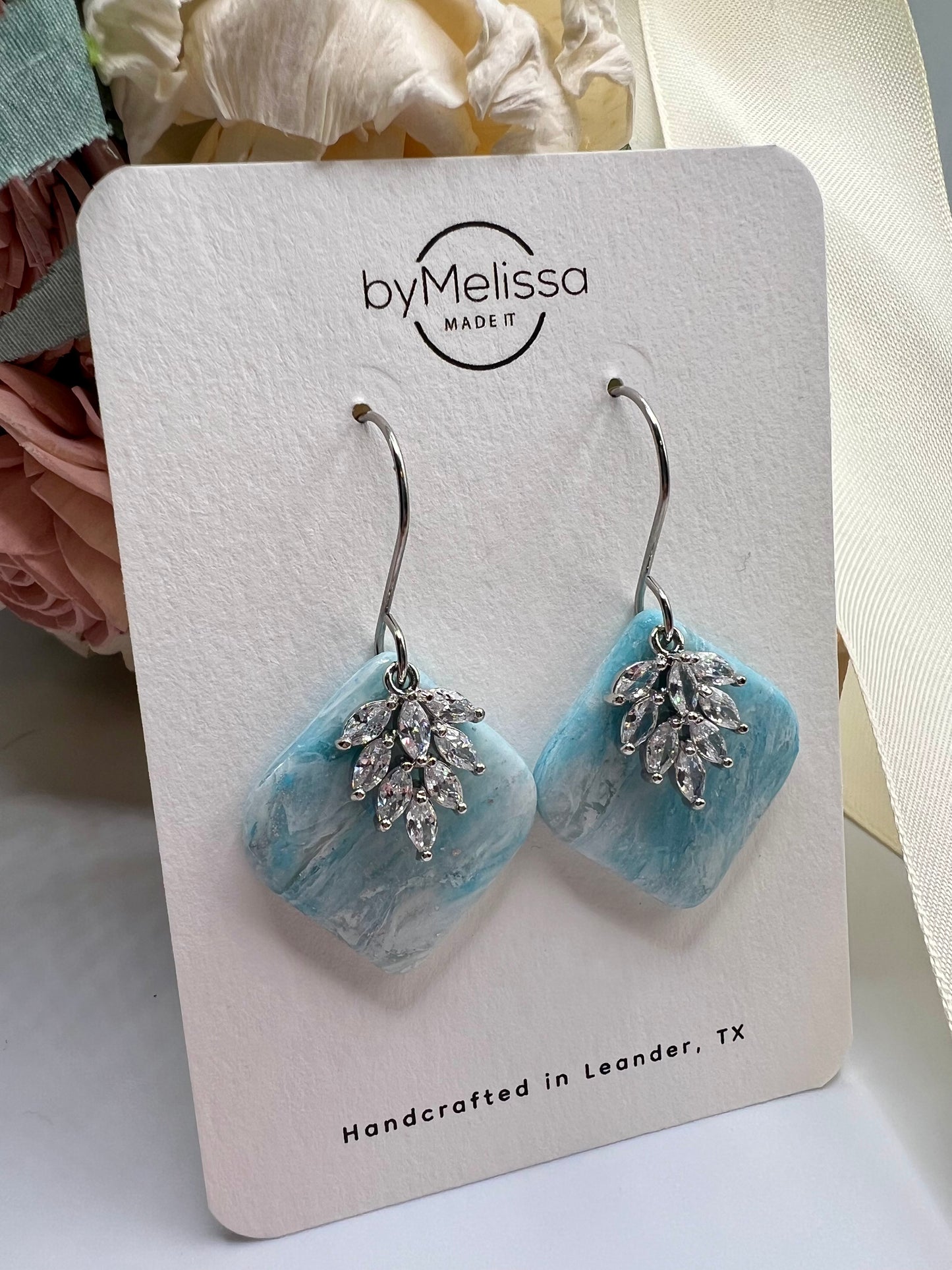 Crystal blue and white rounded square drop earring with silver cubic zirconia feather charm