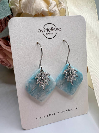 Crystal blue and white rounded square drop earring with silver cubic zirconia feather charm